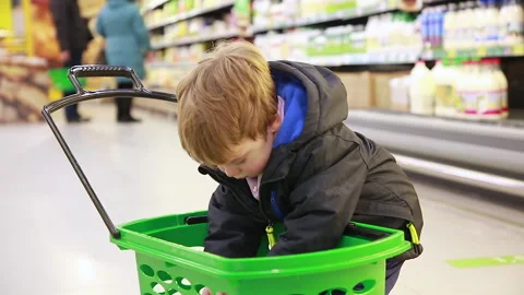The boy inspects the purchases Stock Footage 167014618