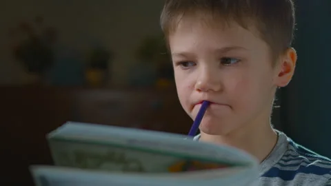 The boy is inspired by an idea and quickly writes it down in his notebook. Stock Footage 302877015