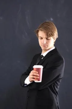 Boy in the jacket with a cup of coffee  Stock Photos
