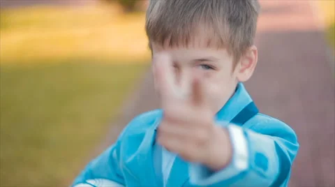 Boy Jacket Shows the Camera and Smiling Stock Footage 68804509