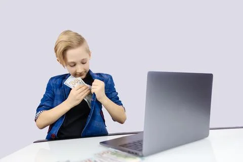 A boy in a jacket works at a computer Stock Photos
