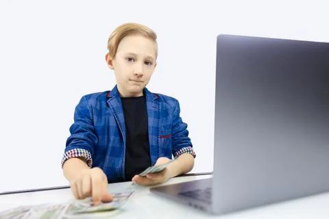 A boy in a jacket works at a computer Foto stock