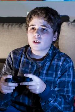 Boy with joystick playing computer game at home. Foto stock