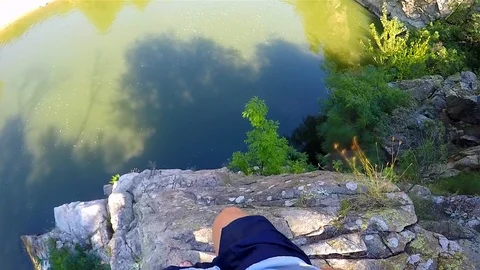 A boy jumped into the river from the high rocks Stock Footage 114623243
