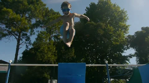 Boy jumping and diving in Swimming Pool. Kids. Slow Motion Stock Footage 33824313