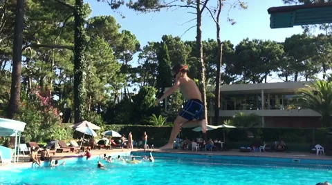 Boy jumping and diving in Swimming Pool -Slow Motion-  HD Stock Footage 61846777