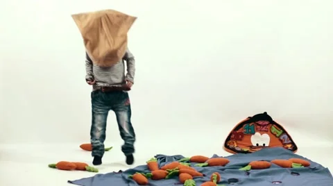 Boy jumping with a bag on his head Stock Footage 48237679
