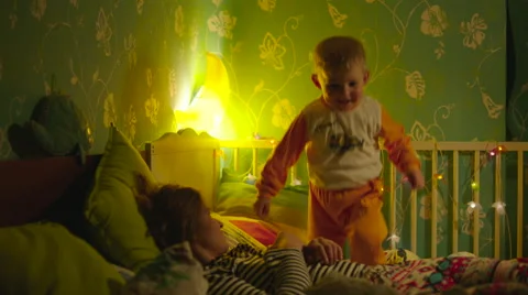 Boy Jumping in Bed slow Stock Footage 56725289