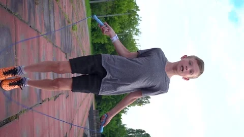 A boy is jumping on a blue rope 動画素材 277408544
