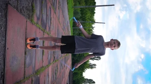 A boy is jumping on a blue rope 스톡 동영상 277408546