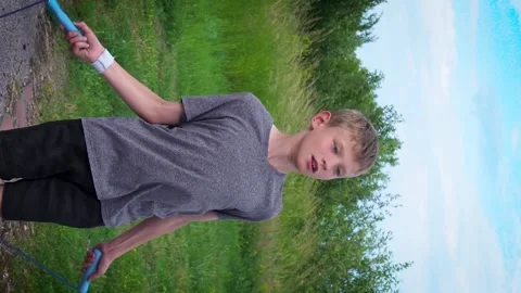 A boy is jumping on a blue rope Video stock 277408843