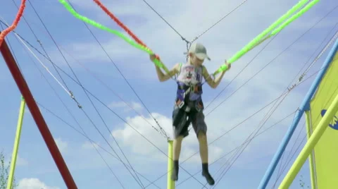 Boy jumping on the bungee child Stock Footage 66014286