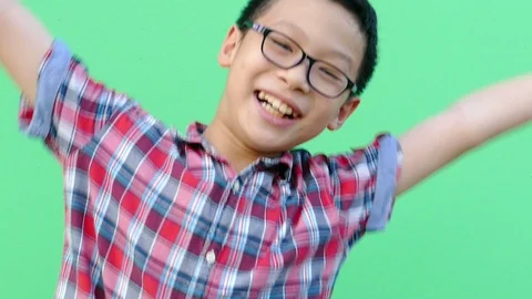 Boy jumping in front of green screen,slow motion. Stock Footage 90688509