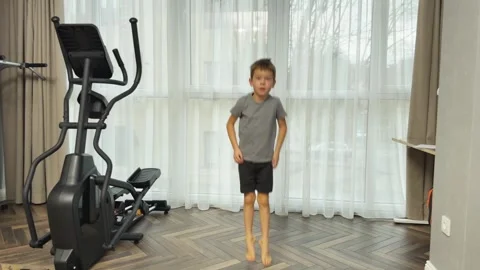 Boy jumping high in place at home, Concept of energetic child workout and Stock-Footage 341865341