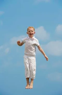 Boy jumping in mid-air Stock Photos