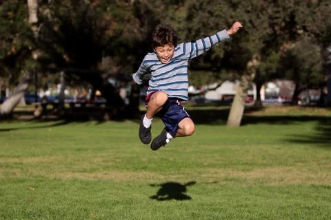 Boy jumping in park Stock Photos