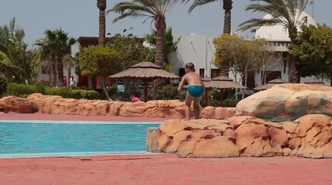 Boy jumping into the pool Stock Footage 54074449