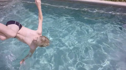 Boy jumping in the pool. Video stock 66007007