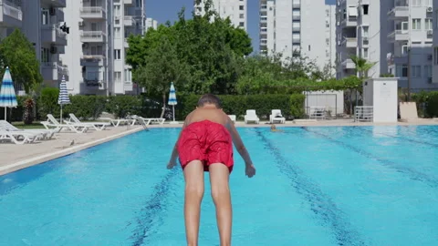 Boy jumping into the pool Stock Footage 314151730