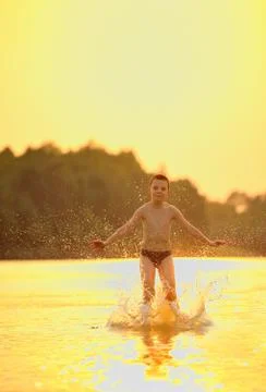 Boy jumping in river Stock Photos