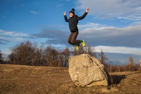 Boy jumping off a rock Stock Photos