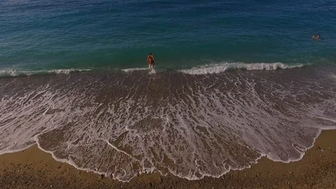 Boy jumping in sea view over Stock Footage 100160921