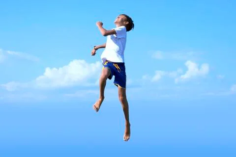 Boy jumping into the sky Stock Photos
