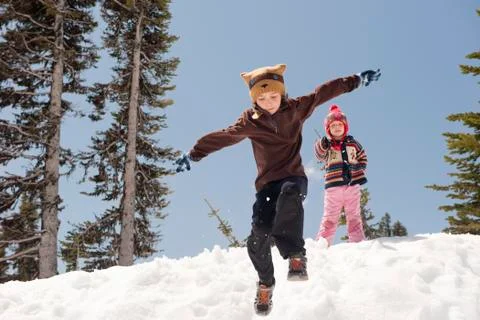 Boy jumping in snow Stock Photos