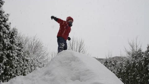 Boy jumping on a snowy mountain Stock Footage 149456733