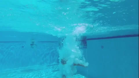 Boy jumping into the swimming pool. Stock Footage 40722996