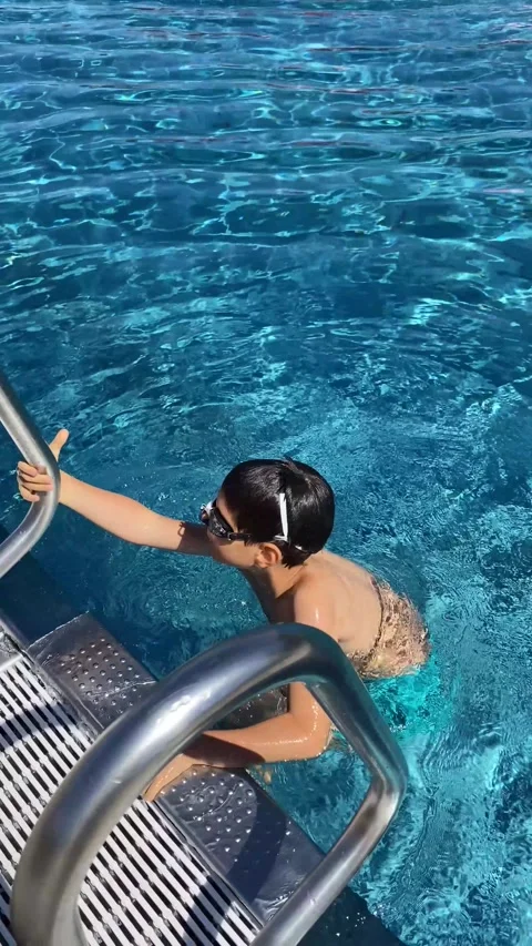 Boy Jumping into Swimming Pool Wearing Fins. Stock Footage 342281543