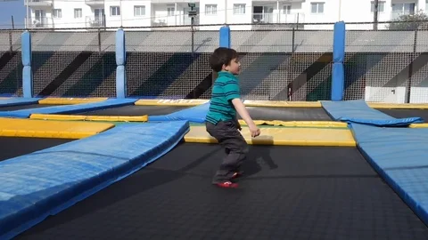 Boy jumping on trampoline Stock Footage 104458307