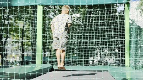 A boy is jumping on a trampoline 스톡 동영상 280888842