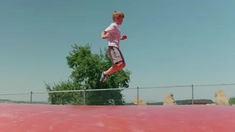 A Boy is Jumping on a Trampoline Stock Footage 344423740