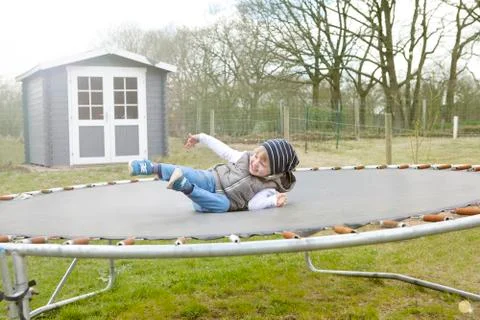 Boy jumping on trampoline Photos