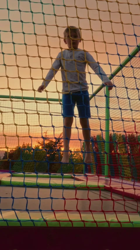 Boy Jumping on Trampoline in Playground. Vertical video Stock Footage 313779249