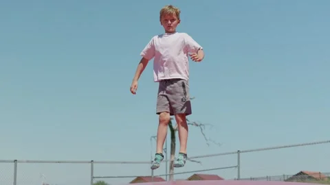 Boy is Jumping on a Trampoline Slow Motion Stock-Footage 345595832