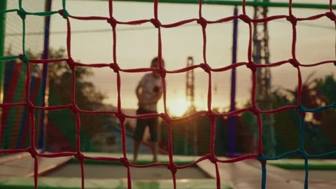 Boy Jumping on Trampoline at Sunset City Festival Slow Motion Video stock 313560188