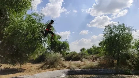 A boy jumping to tree in the pool in slow motion Stock Footage 134216811