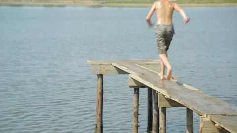 Boy jumping into water Video stock 99899419