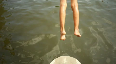 Boy jumping into water from a springboard Stock Footage 1105645