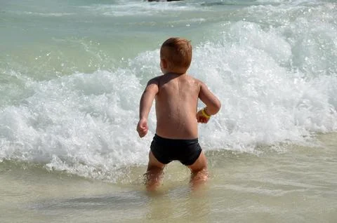 Boy jumping wave Stock Photos