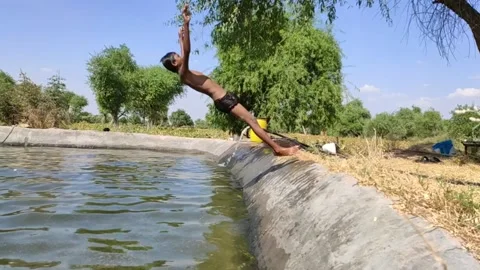 A boy jumps backwards into the pool, slow motion footage Stock Footage 134216835