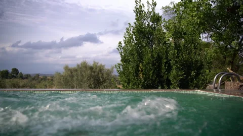 Boy Jumps Into Infinity Pool and Disappears Underwater Stock Footage 343358519