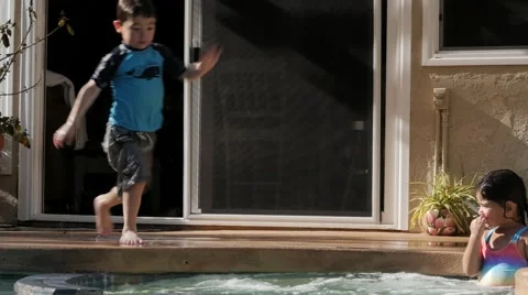 BOY JUMPS INTO JACUZZI SLOW MOTION. Stock Footage 54621989
