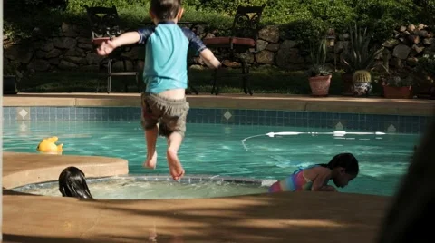 BOY JUMPS INTO JACUZZI SLOW MOTION Stock Footage 54622000