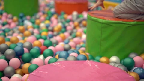 The boy jumps over the pool with balls. Entertainment Center Stock Footage 180530115