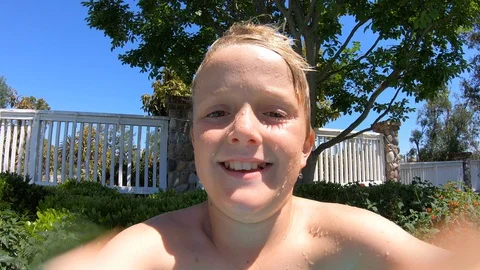 Boy Jumps Into Pool Handheld Stockbeeldmateriaal 129780863