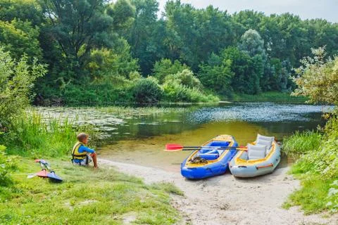 Boy kayaking on the river 写真素材
