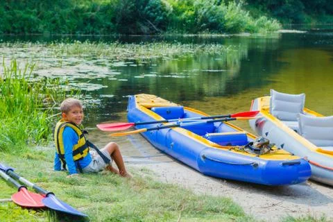 Boy kayaking on the river Photos